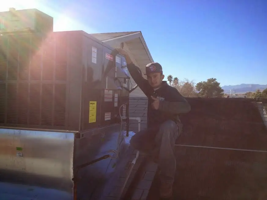 HVAC technician performing HVAC Inspection on a rooftop unit in Mount Vernon